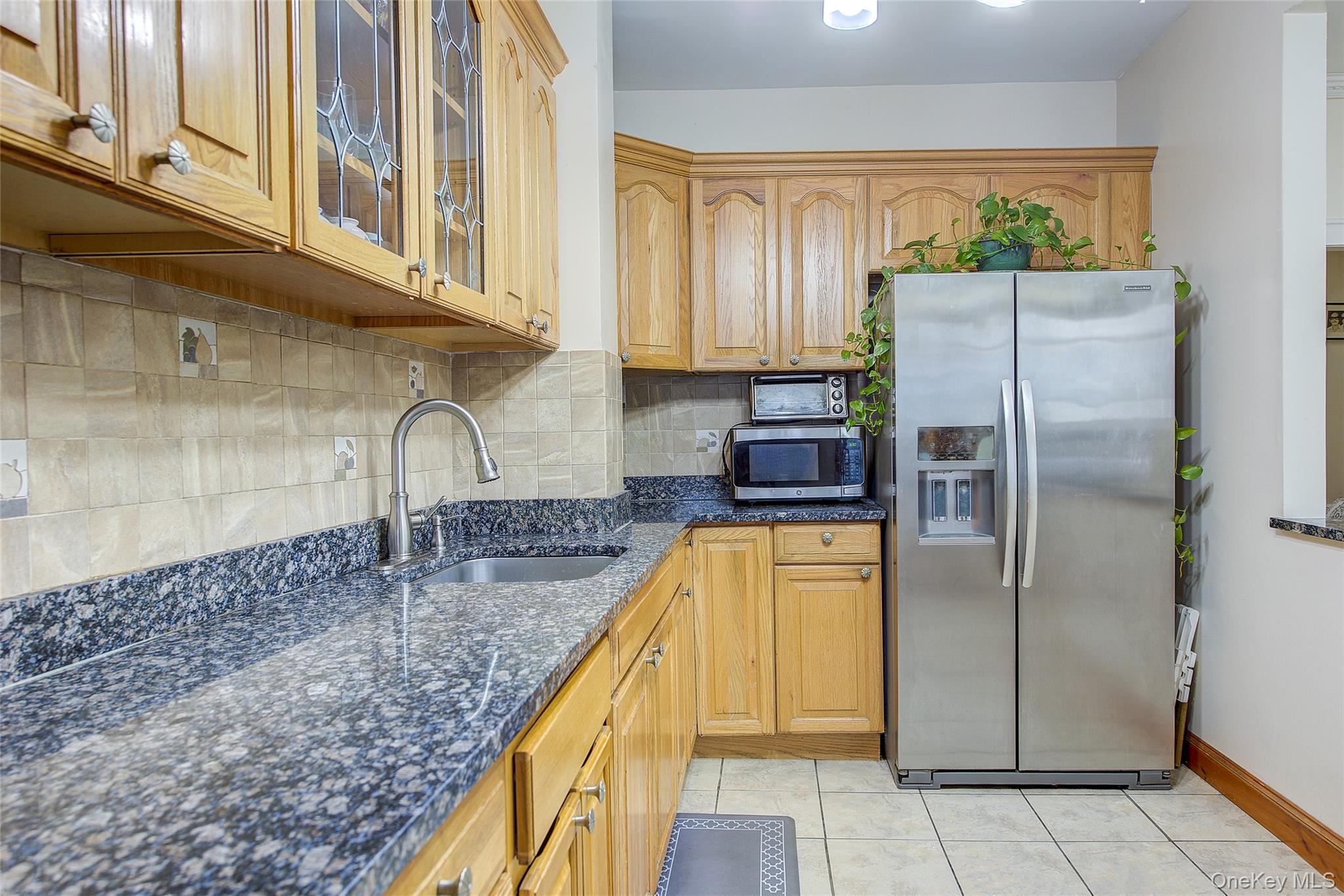 161-10 84th Road Queens, NY 11432 - Photo 17 of 44 a kitchen with stainless steel appliances granite countertop a refrigerator a stove and a sink
