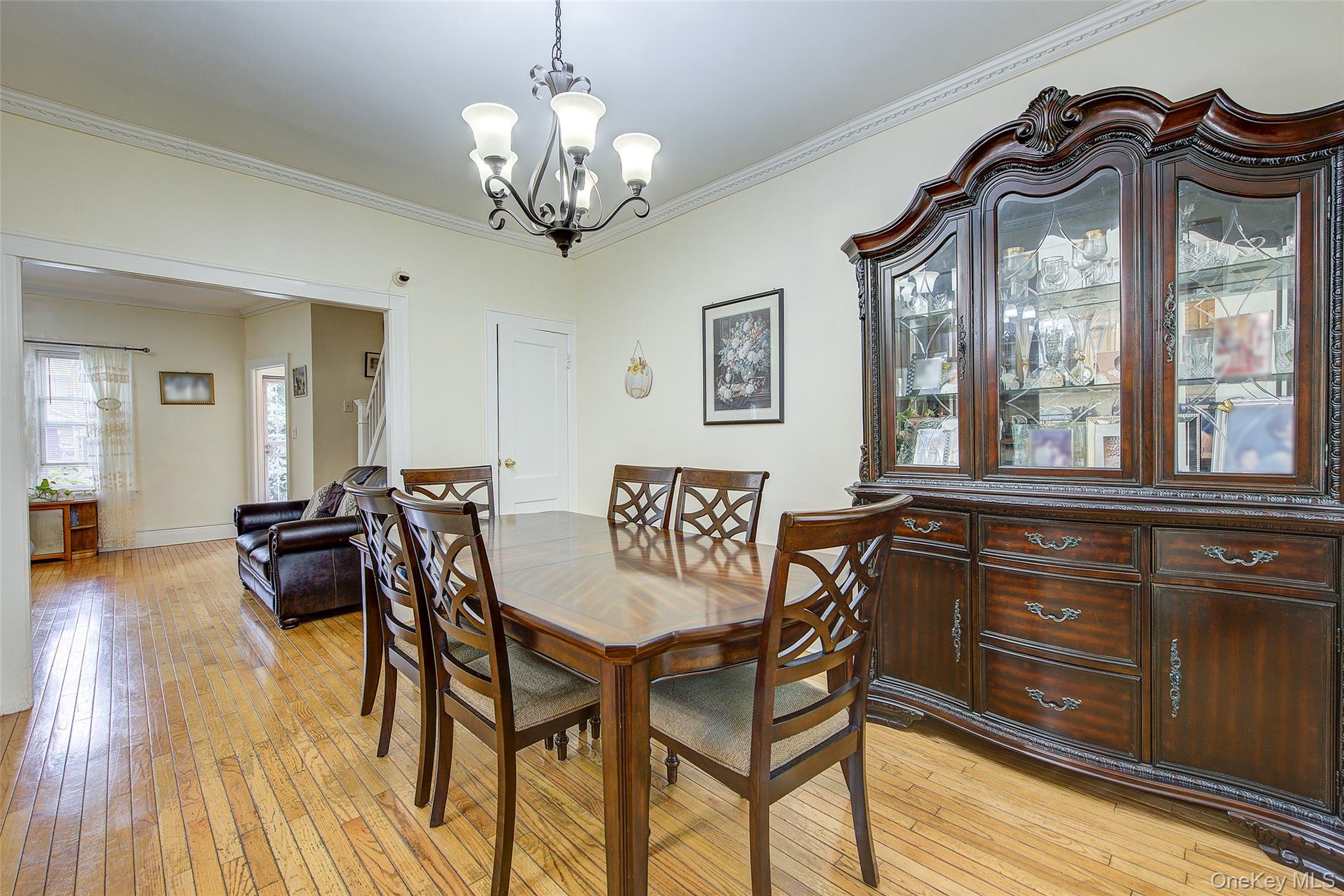 161-10 84th Road Queens, NY 11432 - Photo 21 of 44 a view of a dining room with furniture and chandelier