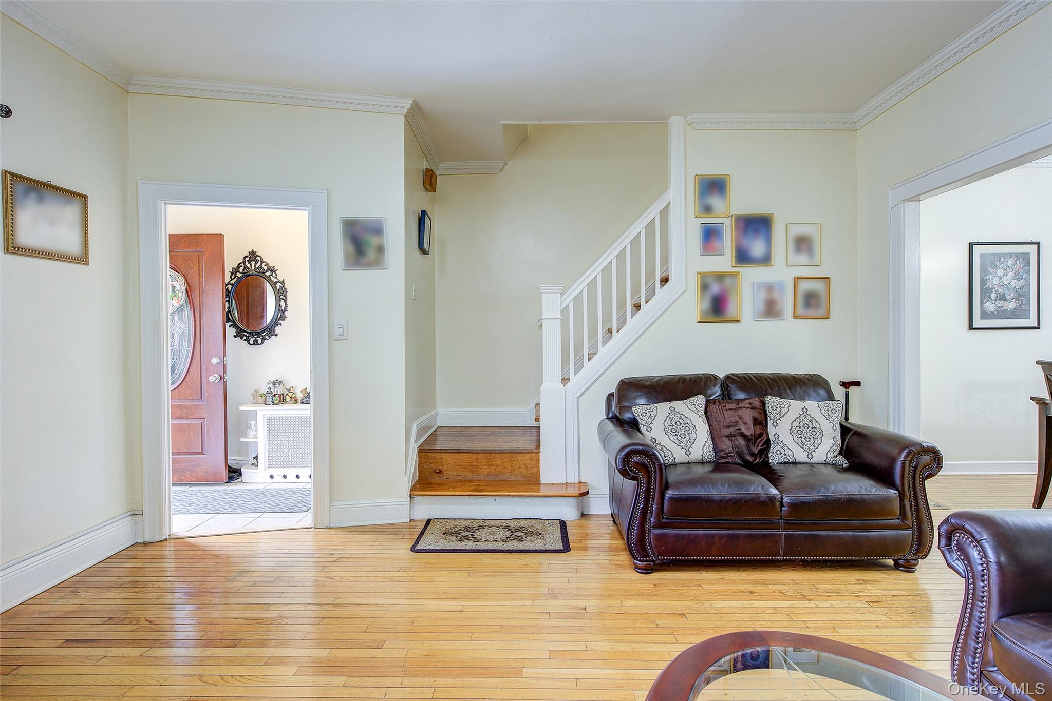 161-10 84th Road Queens, NY 11432 - Photo 23 of 44 a living room with furniture and a floor to ceiling window