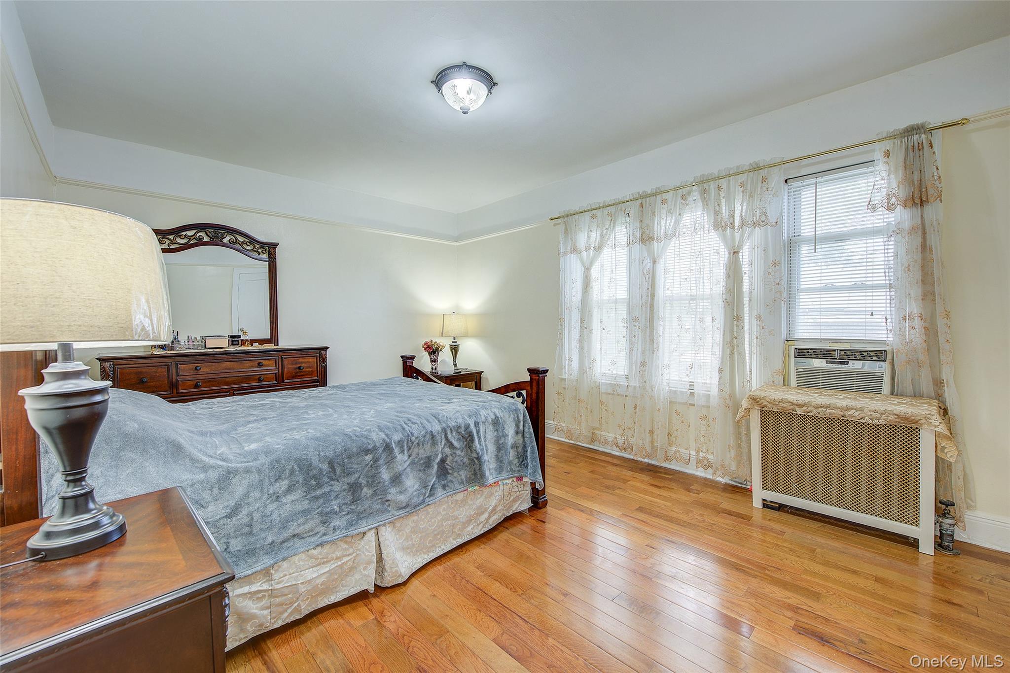 161-10 84th Road Queens, NY 11432 - Photo 25 of 44 a bedroom with a bed and window