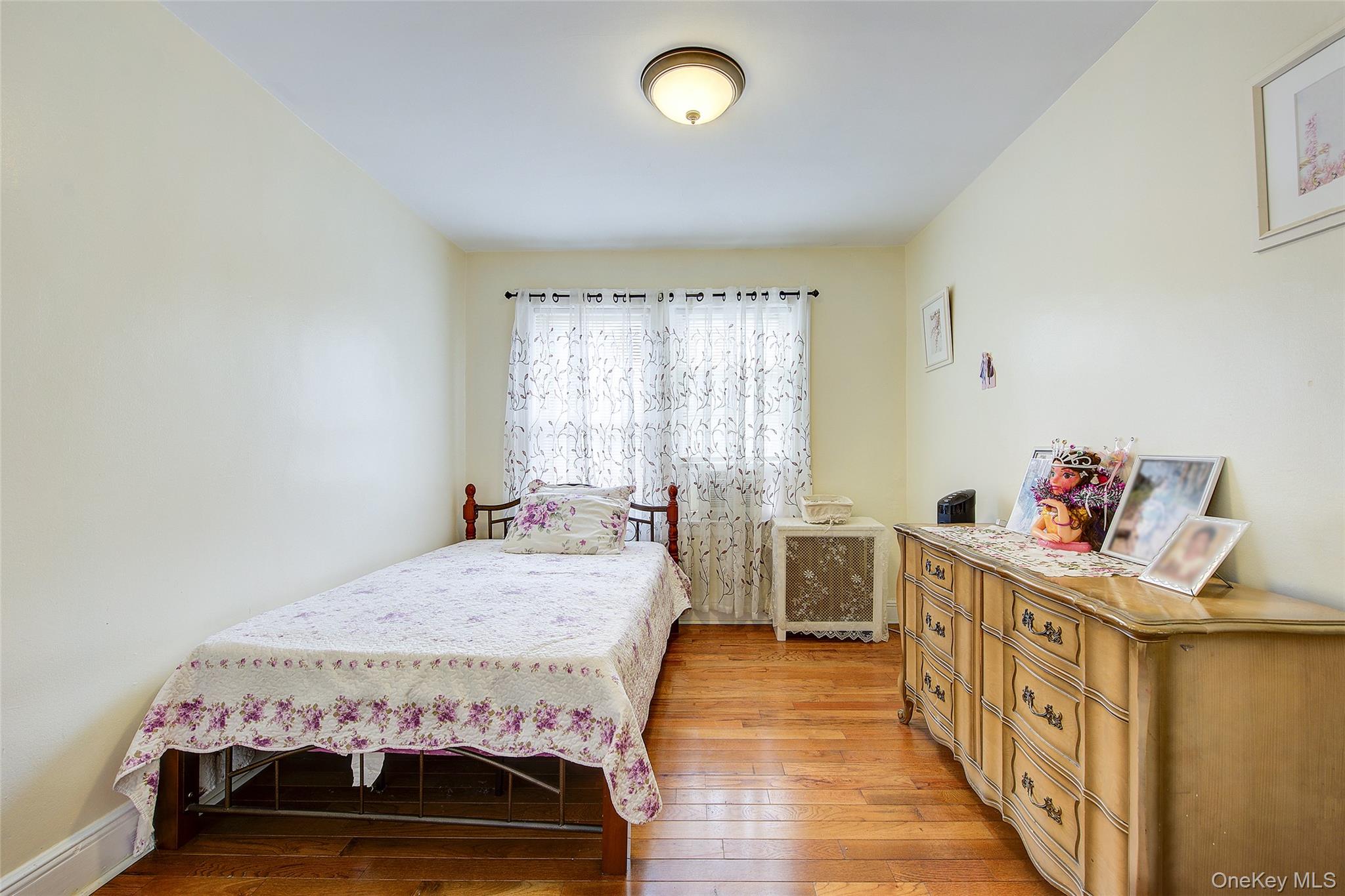 161-10 84th Road Queens, NY 11432 - Photo 29 of 44 a bedroom with a bed and a table