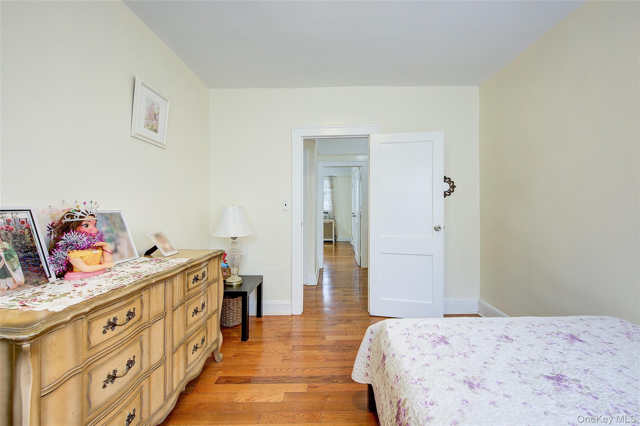 161-10 84th Road Queens, NY 11432 - Photo 30 of 44 a bedroom with a bed and a dresser in it