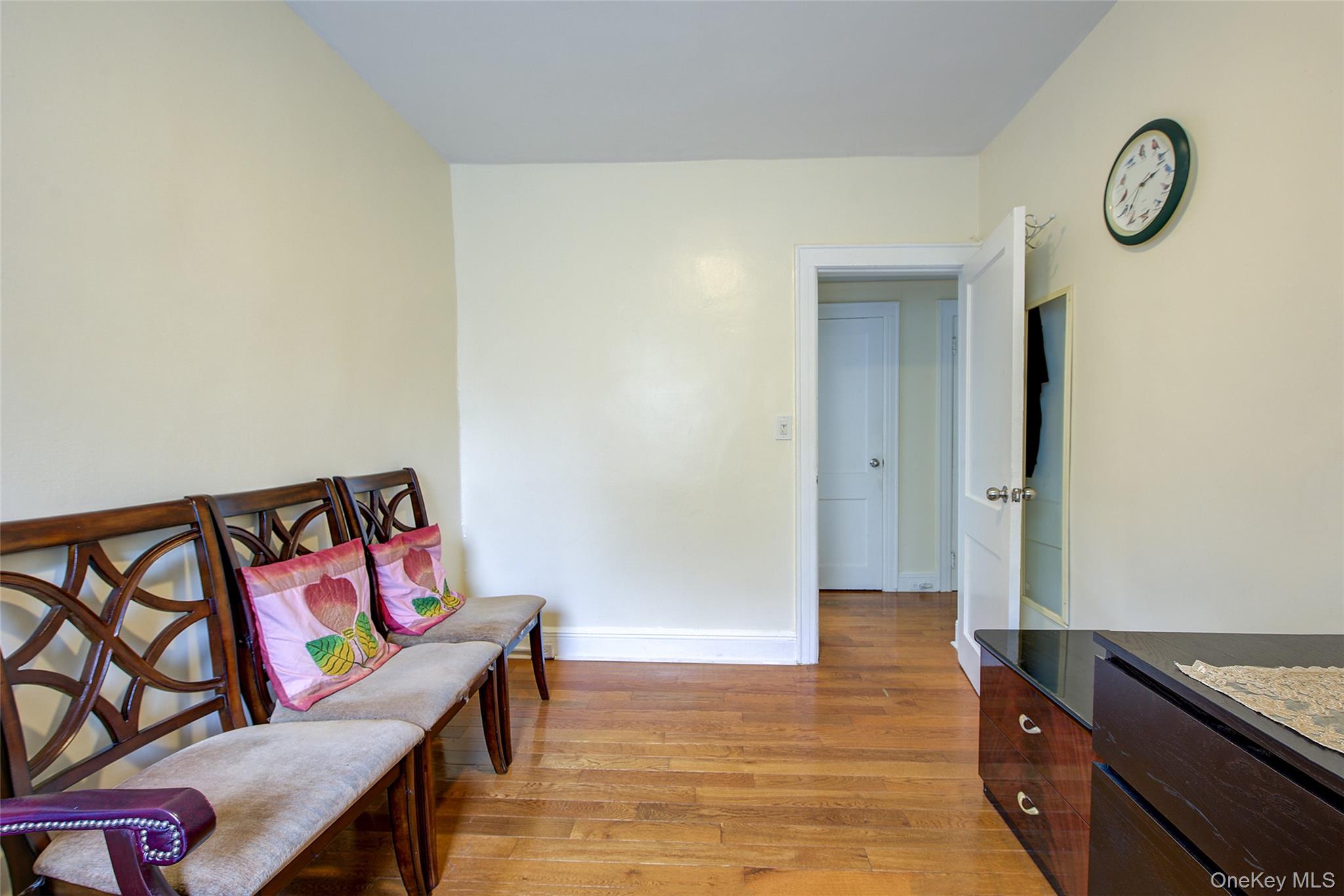 161-10 84th Road Queens, NY 11432 - Photo 32 of 44 a hallway with painting on the wall and a window