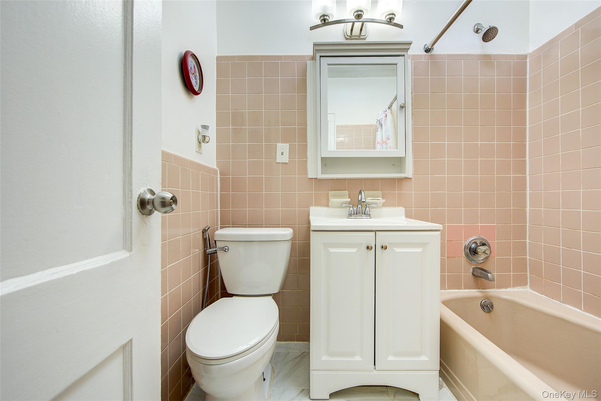 161-10 84th Road Queens, NY 11432 - Photo 33 of 44 a bathroom with a toilet sink and mirror