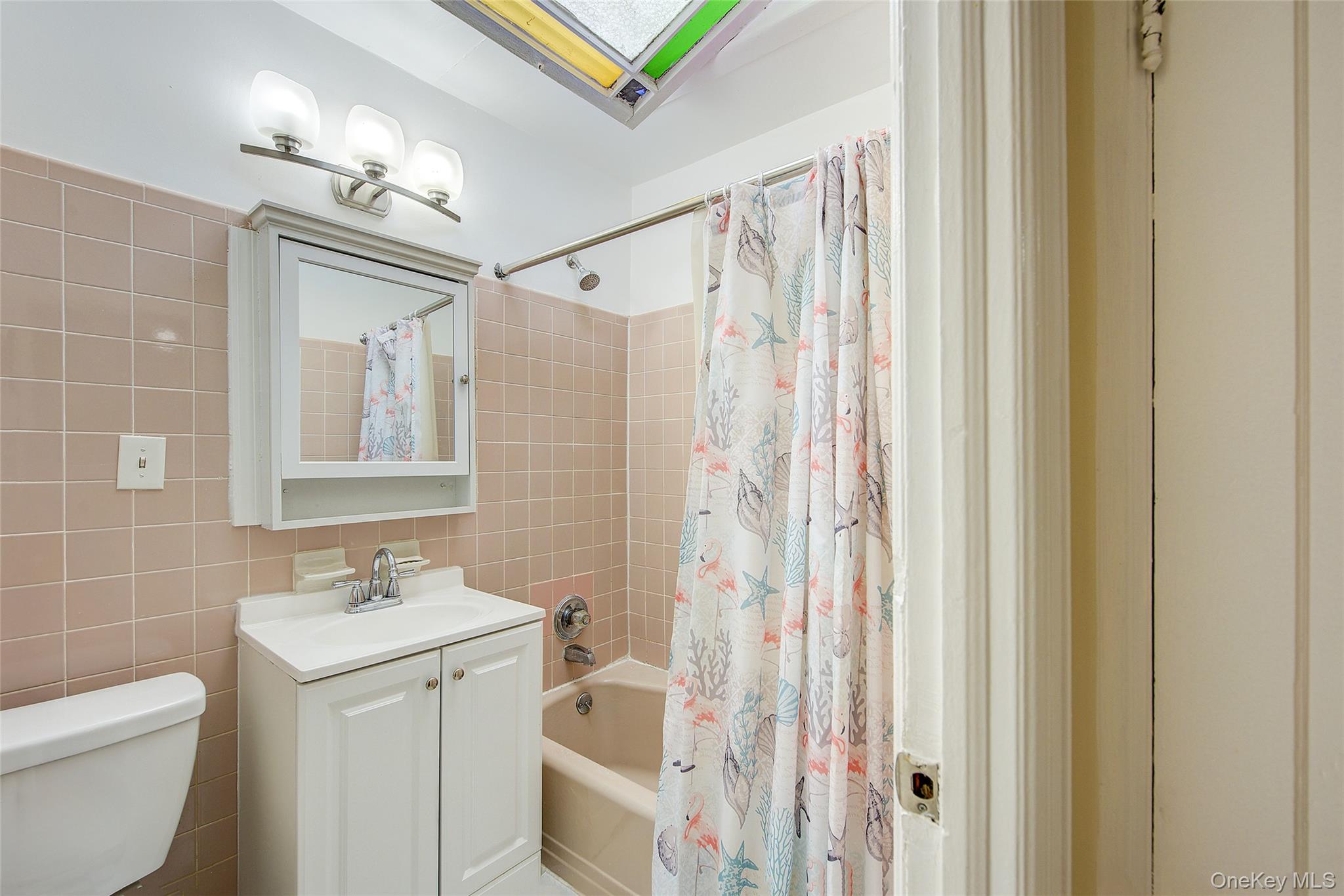 161-10 84th Road Queens, NY 11432 - Photo 34 of 44 a bathroom with a sink a toilet a mirror and shower