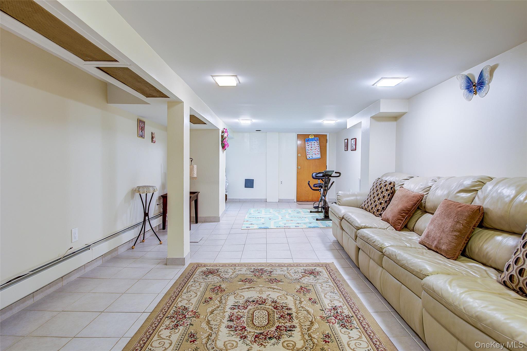 161-10 84th Road Queens, NY 11432 - Photo 38 of 44 a living room with furniture and a rug