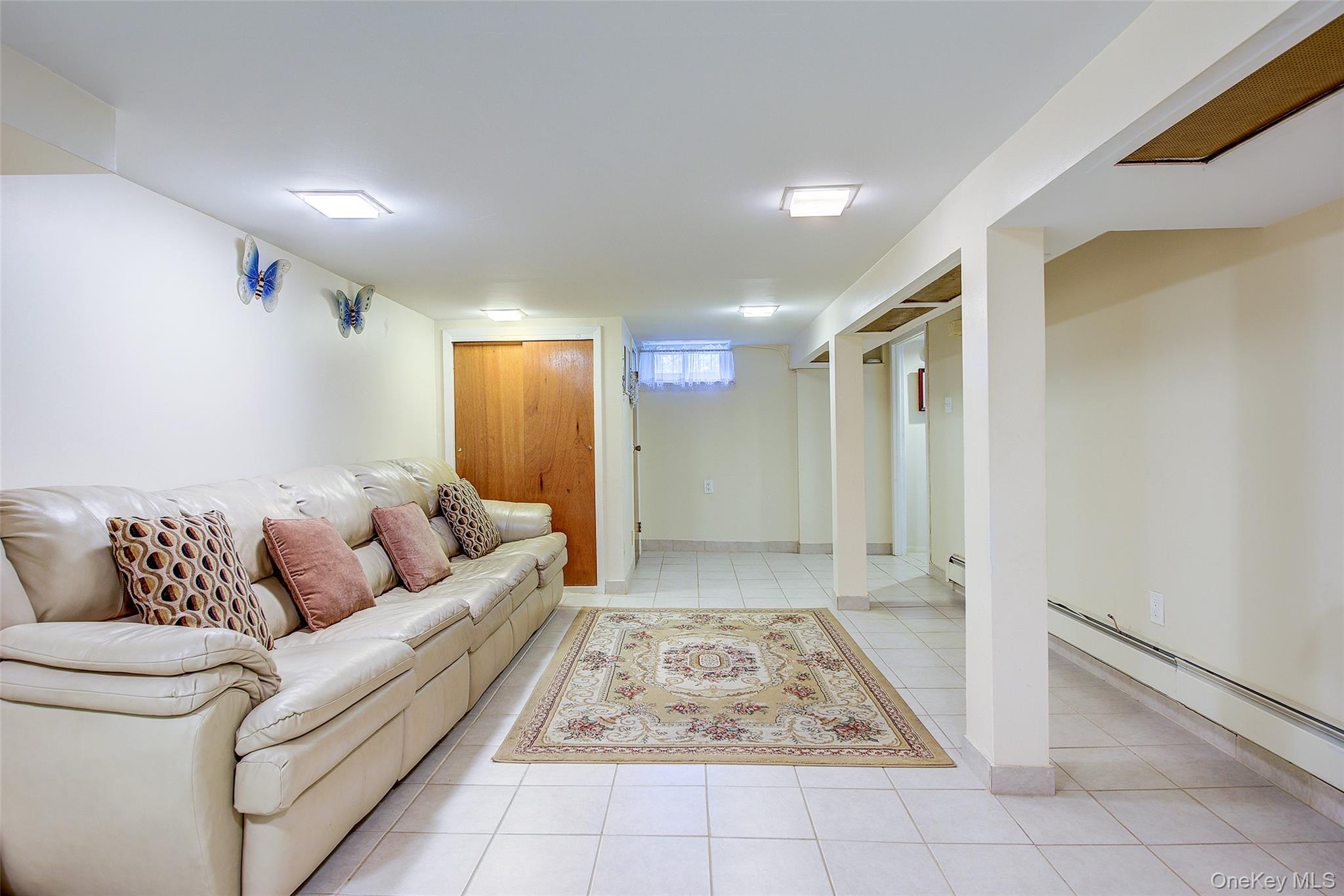 161-10 84th Road Queens, NY 11432 - Photo 39 of 44 a living room with furniture and a rug