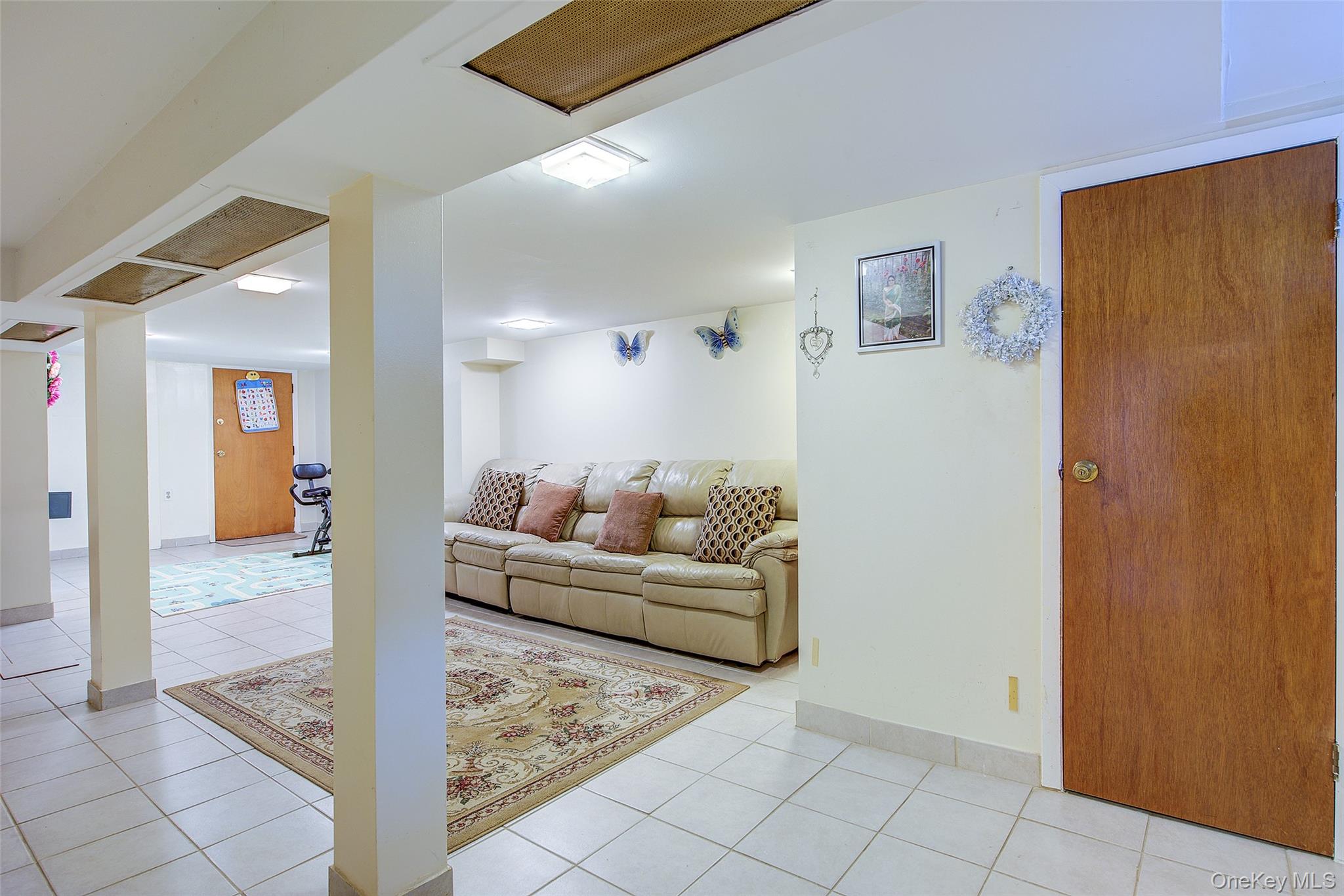 161-10 84th Road Queens, NY 11432 - Photo 40 of 44 a living room with furniture and a rug