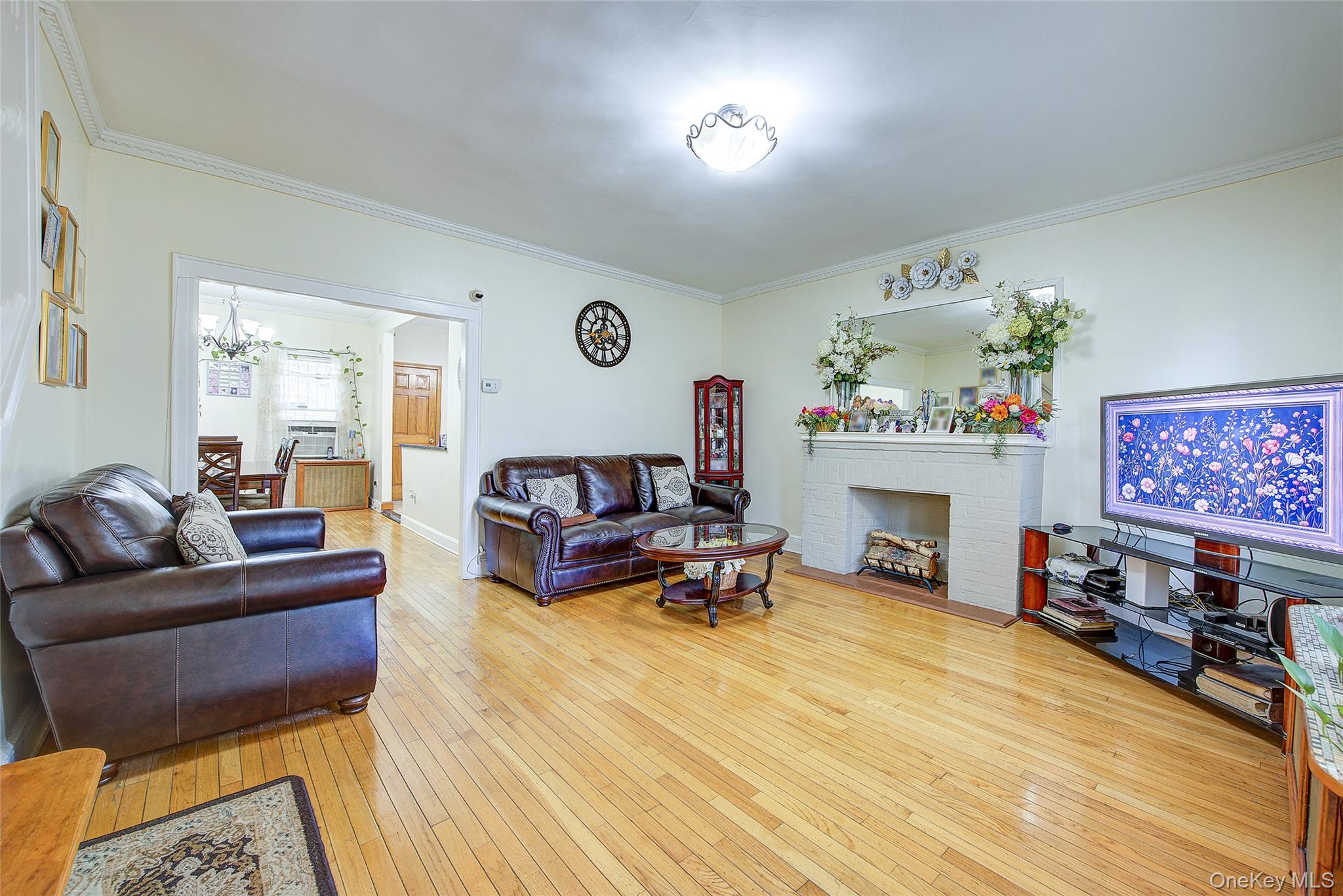 161-10 84th Road Queens, NY 11432 - Photo 8 of 44 a living room with furniture and a fireplace