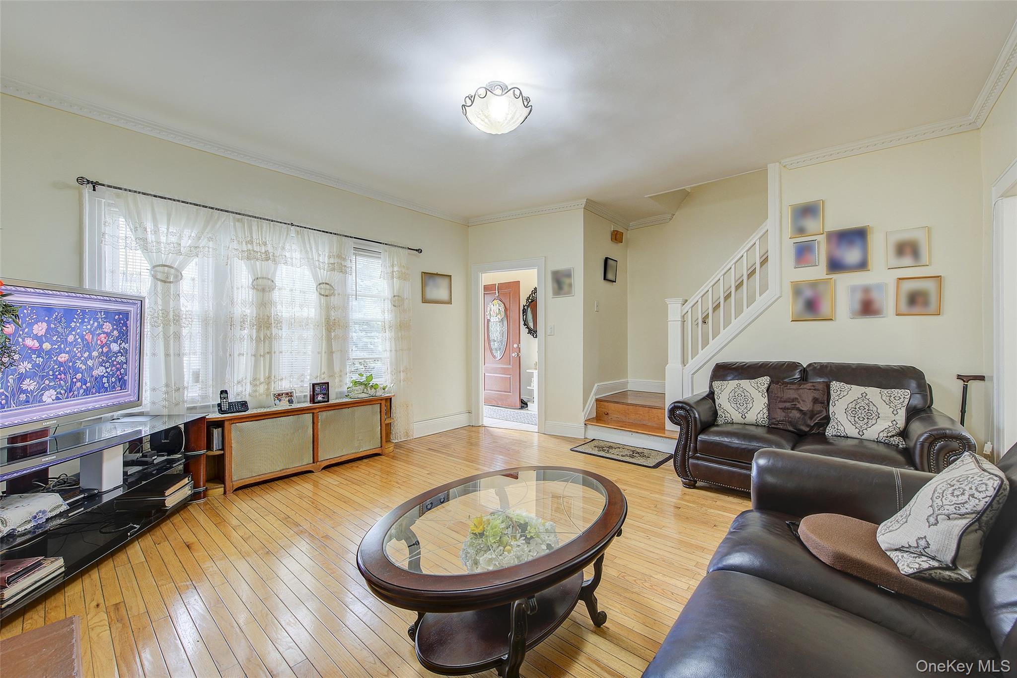 161-10 84th Road Queens, NY 11432 - Photo 9 of 44 a living room with furniture and a wooden floor
