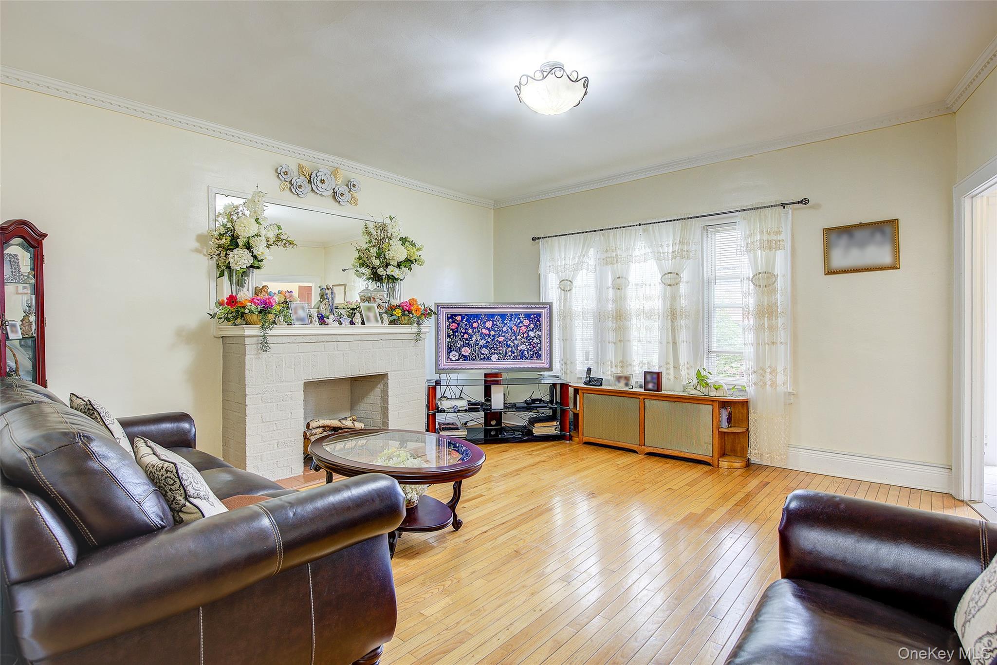 161-10 84th Road Queens, NY 11432 - Photo 10 of 44 a living room with furniture and a fireplace