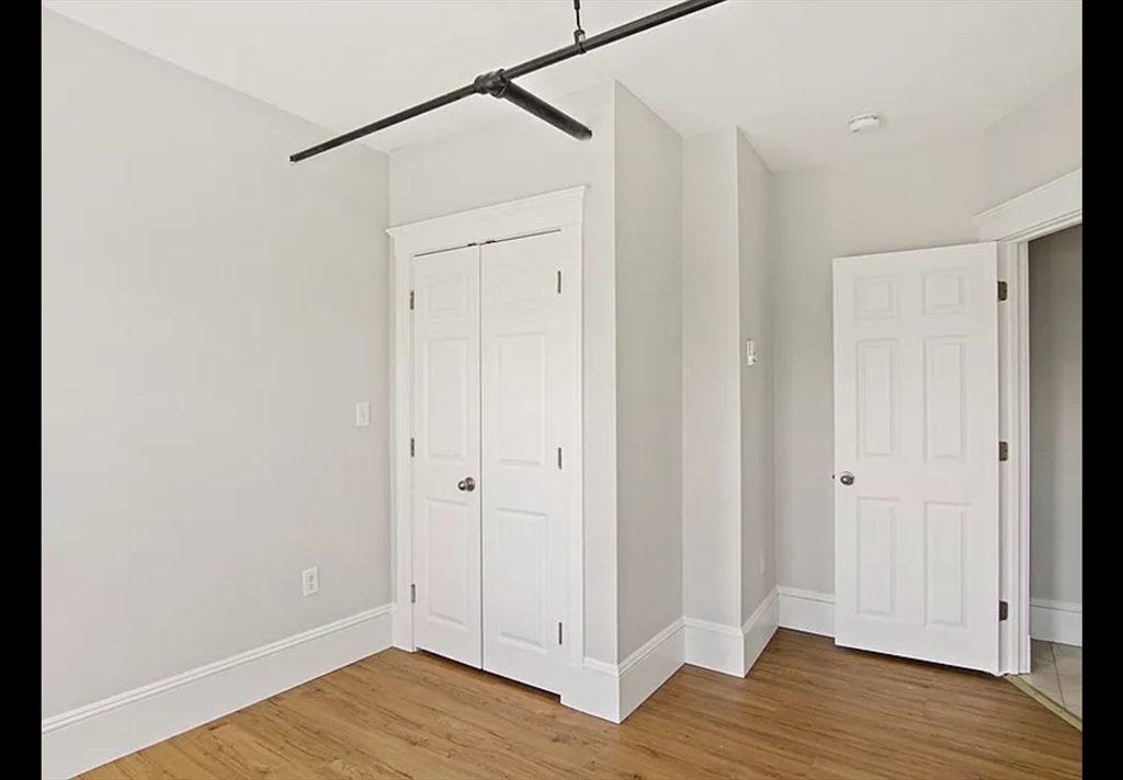 2 Redfield Street, Unit 2 Boston, MA 02122 - Photo 6 of 14 a view of an empty room with wooden floor