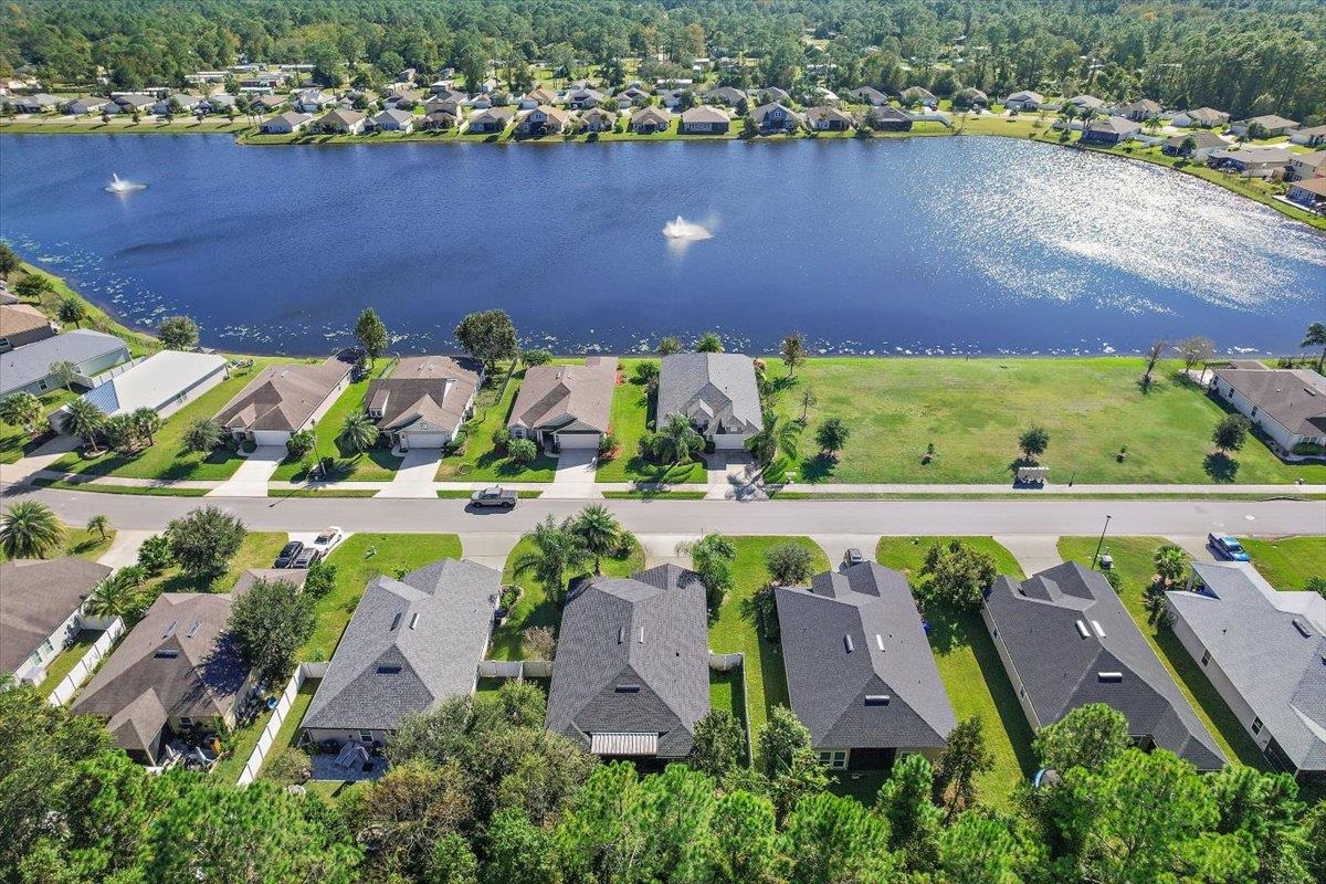 an aerial view of a house with a lake view