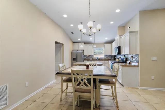 a view of a dining room with furniture and chandelier