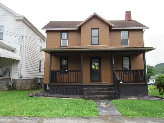 a front view of a house with a yard