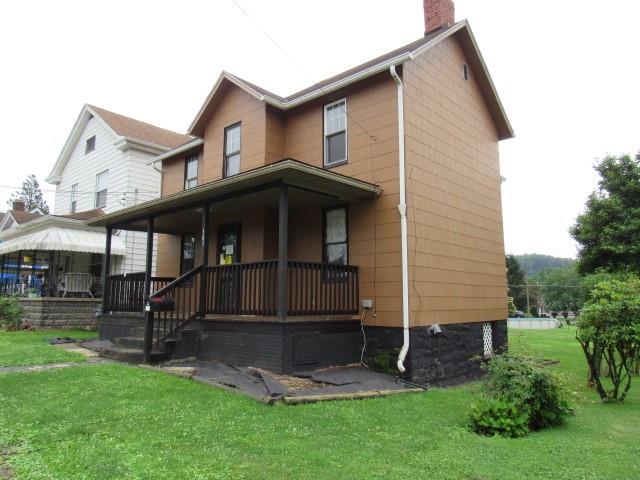 103 Memorial Street Dunbar, PA 15431 - Photo 3 of 18 a front view of a house with a yard