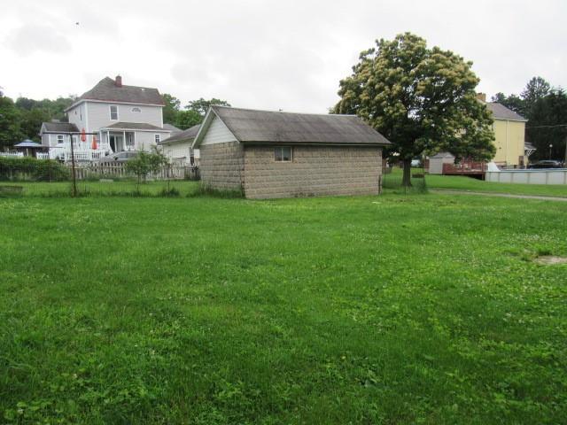 103 Memorial Street Dunbar, PA 15431 - Photo 4 of 18 a front view of a house with a yard and trees