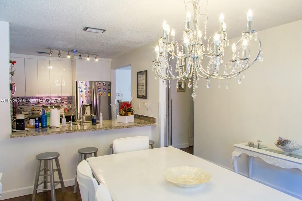 10000 Southwest 147th Court Miami, FL 33196 - Photo 11 of 36 a very nice looking dining room with a table and chandelier