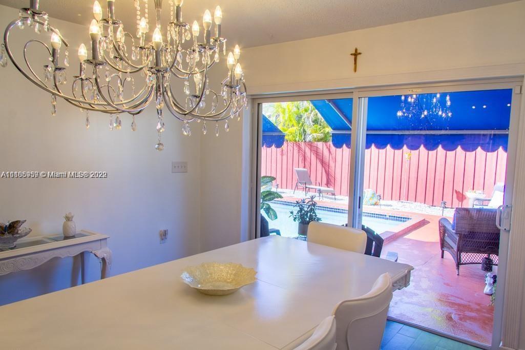10000 Southwest 147th Court Miami, FL 33196 - Photo 13 of 36 a dining room with furniture and a large window
