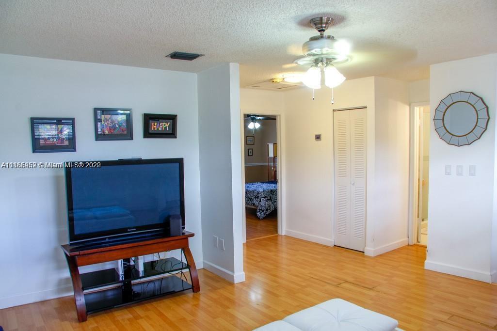 10000 Southwest 147th Court Miami, FL 33196 - Photo 16 of 36 a living room with furniture and a chandelier