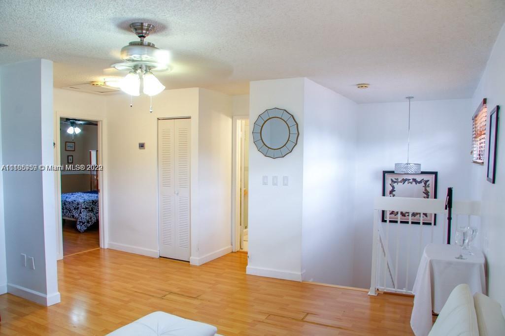 10000 Southwest 147th Court Miami, FL 33196 - Photo 17 of 36 a view of a hallway with wooden floor and a kitchen