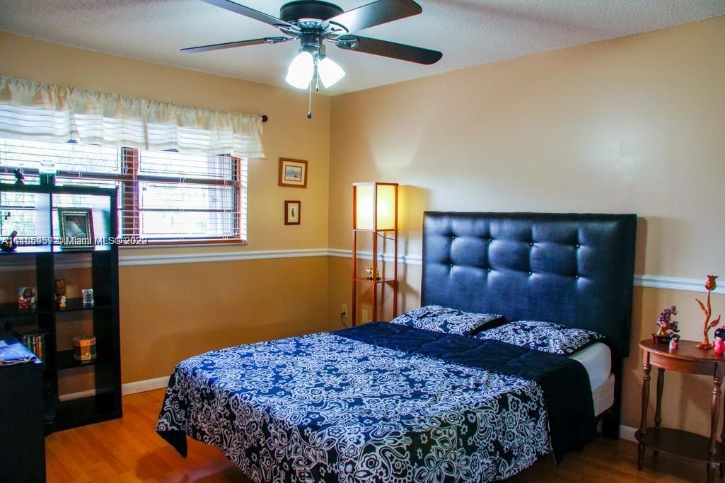 10000 Southwest 147th Court Miami, FL 33196 - Photo 19 of 36 a bedroom with a bed and wooden floor