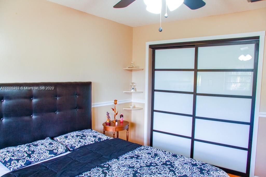 10000 Southwest 147th Court Miami, FL 33196 - Photo 20 of 36 a bedroom with a bed and a dresser