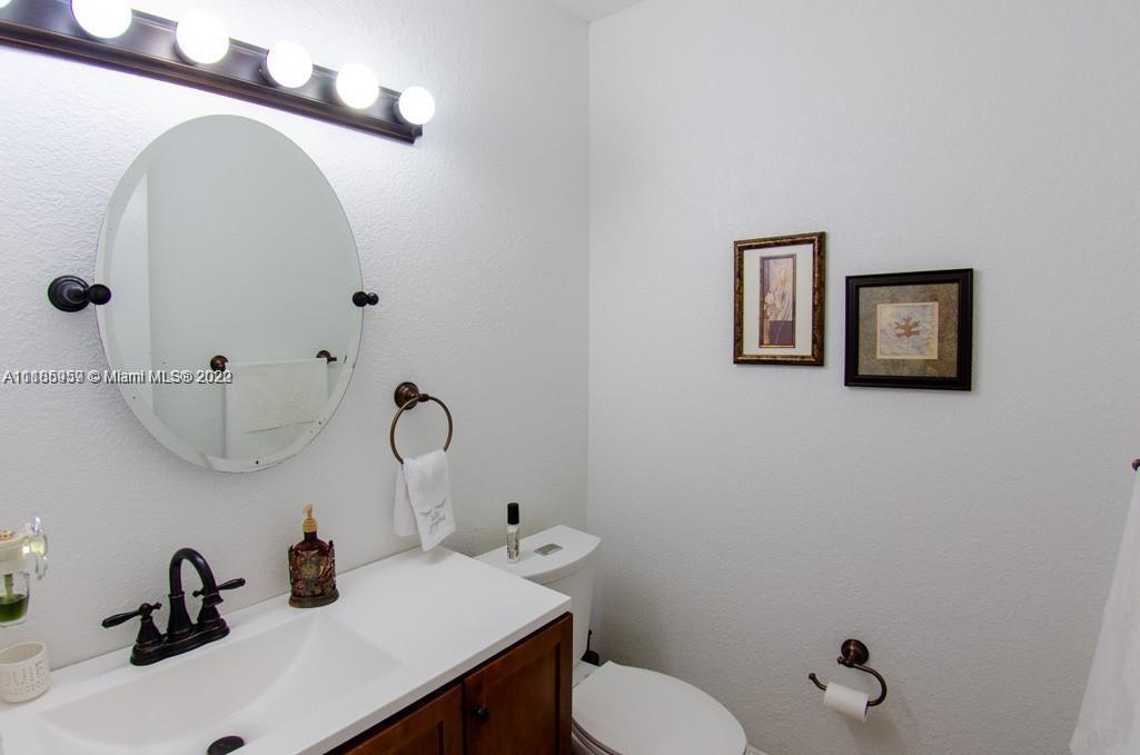 10000 Southwest 147th Court Miami, FL 33196 - Photo 21 of 36 a bathroom with a sink and a mirror