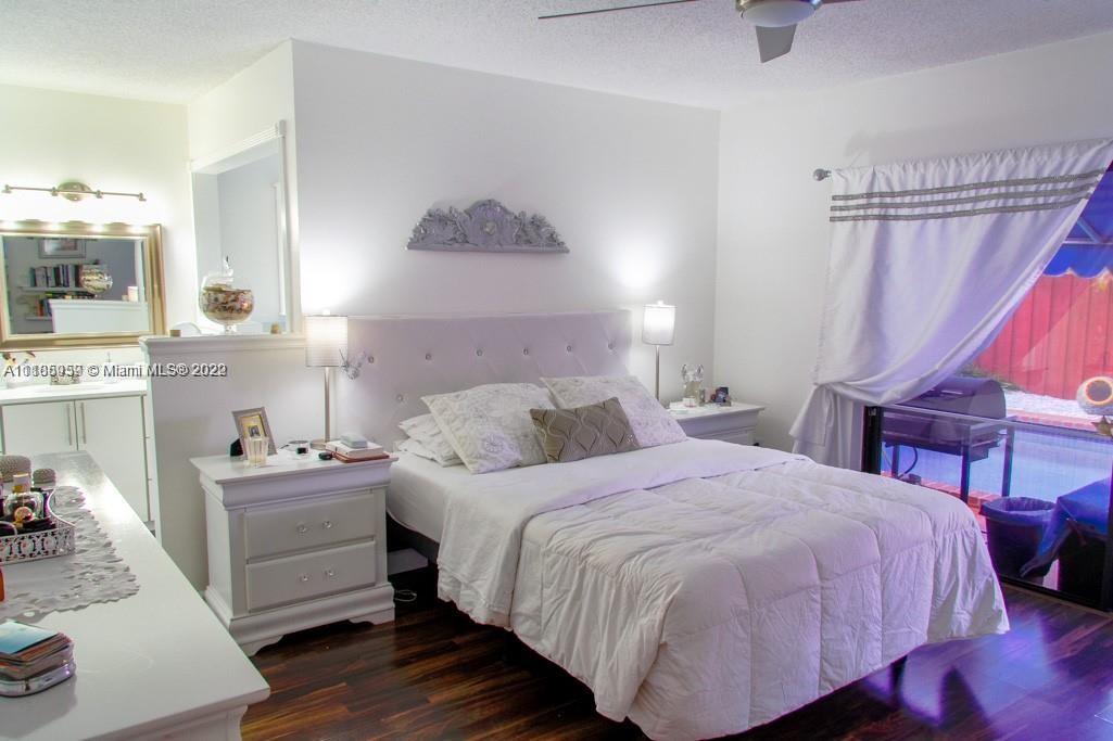 10000 Southwest 147th Court Miami, FL 33196 - Photo 27 of 36 a bedroom with a bed and a table