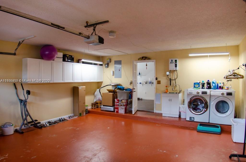 10000 Southwest 147th Court Miami, FL 33196 - Photo 29 of 36 a view of a storage & utility room with two washing machine