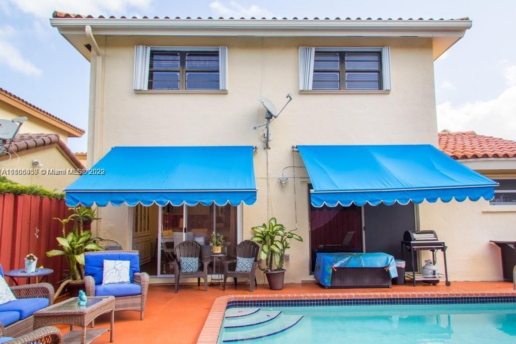 10000 Southwest 147th Court Miami, FL 33196 - Photo 35 of 36 a table and chairs in a patio