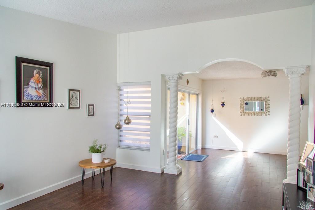 10000 Southwest 147th Court Miami, FL 33196 - Photo 4 of 36 a view of empty room with wooden floor and window