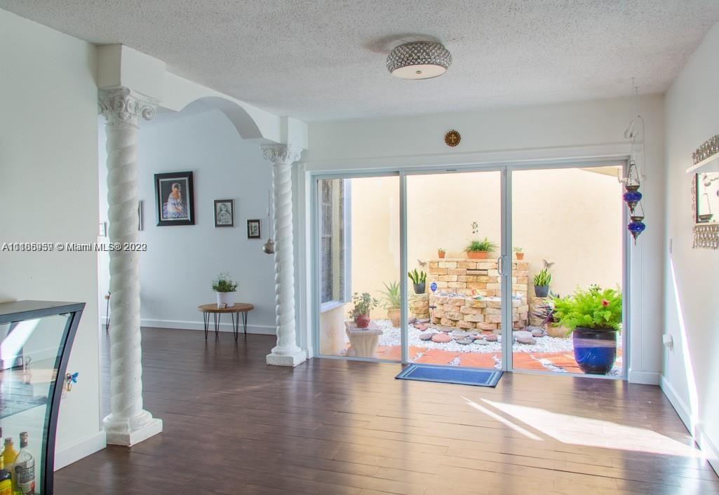 10000 Southwest 147th Court Miami, FL 33196 - Photo 5 of 36 a view of a work space with wooden floor and furniture
