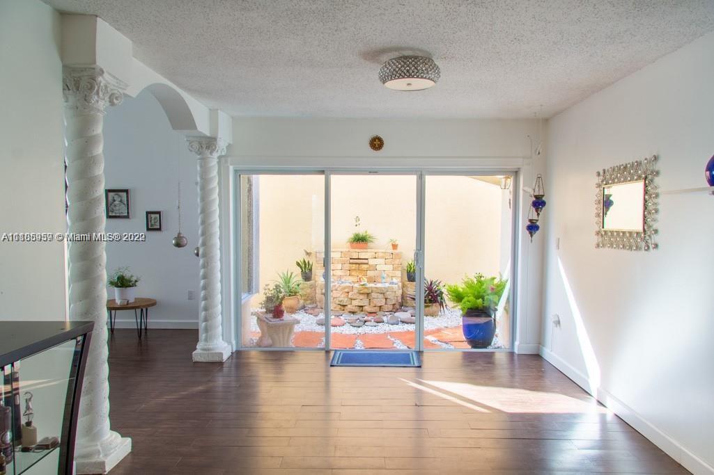 10000 Southwest 147th Court Miami, FL 33196 - Photo 6 of 36 a view of an entryway with wooden floor and windows