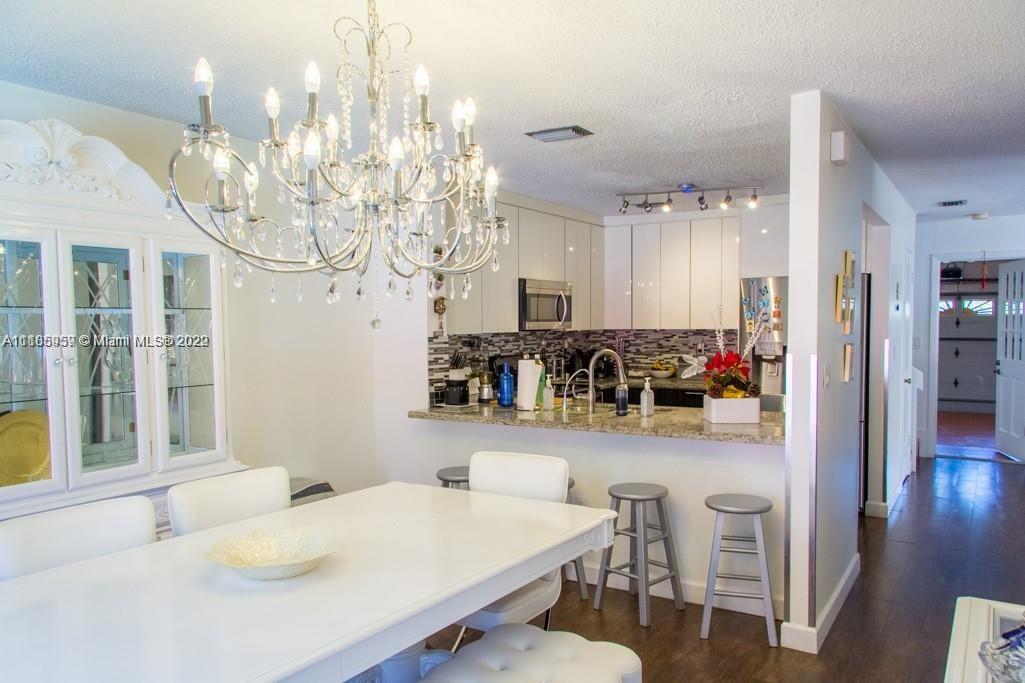 10000 Southwest 147th Court Miami, FL 33196 - Photo 10 of 36 a view of a dining room with furniture and wooden floor