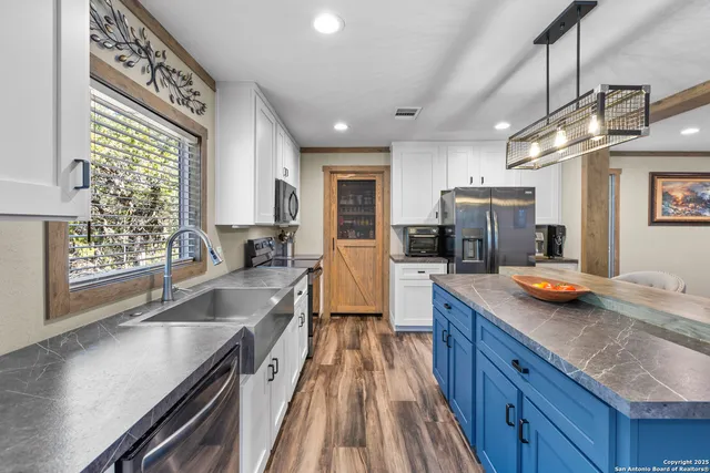 a kitchen with counter top space a sink and appliances
