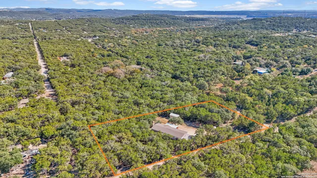 a view of a field with a mountain in the background