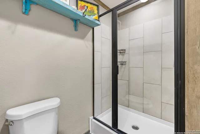 a bathroom with a shower and toilet