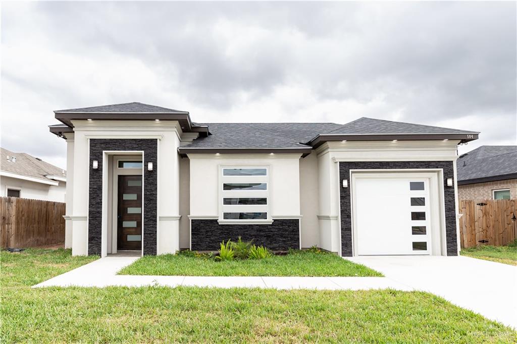 504 Oak Ridge Street Donna, TX 78537 - Photo 1 of 1 Prairie-style home featuring a front lawn and a garage