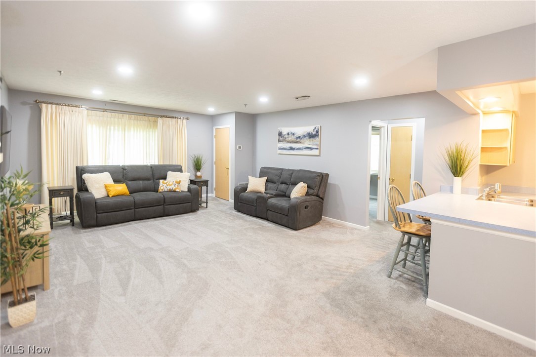 19510 Lorain Road, Unit 101 Cleveland, OH 44126 - Photo 2 of 24 Living room carpeted with recessed lights and a window treatment at the sliding glass door