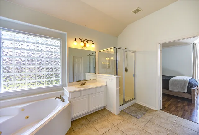 a bathroom with a tub sink and shower