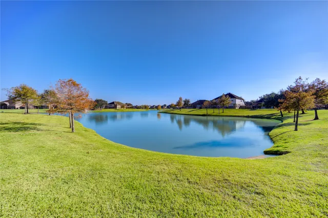 a view of a lake with houses in the back