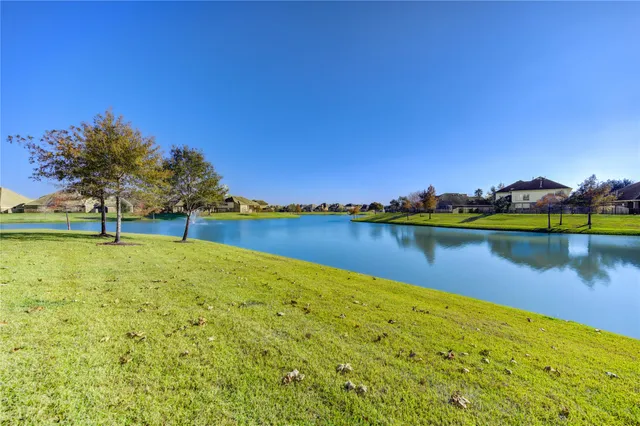 a view of a lake with houses in the background