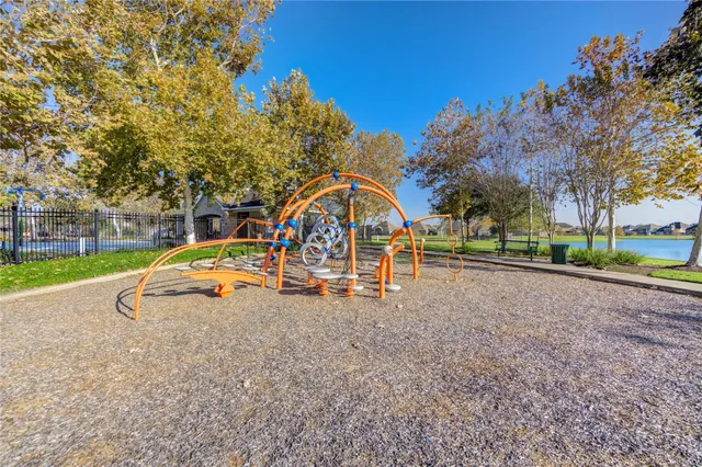 a view of backyard with swimming pool and green space
