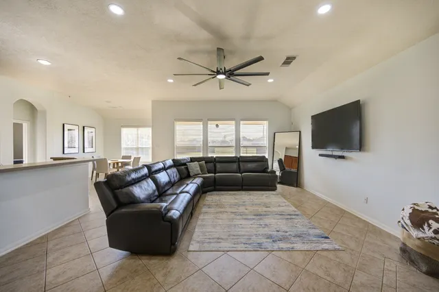 a living room with furniture and a flat screen tv
