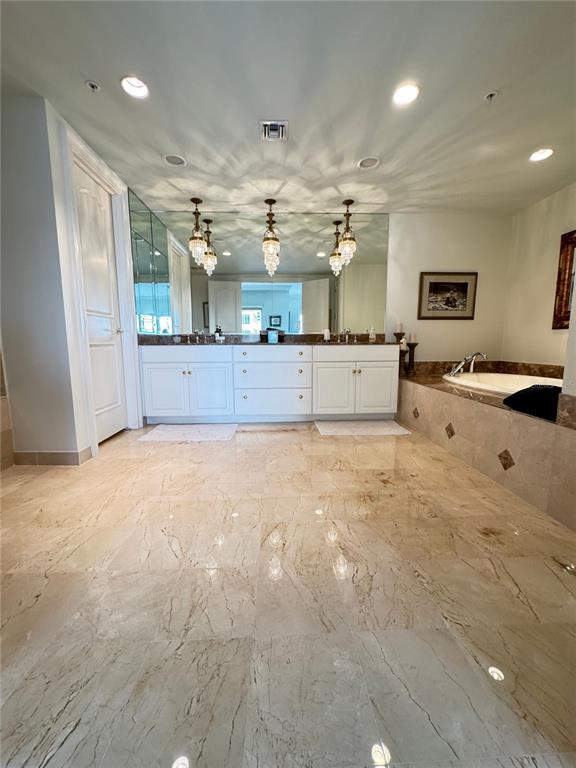 1111 Ritz Carlton Drive, Unit 1404 Sarasota, FL 34236 - Photo 30 of 69 a large kitchen with stainless steel appliances a large counter top a stove and a refrigerator