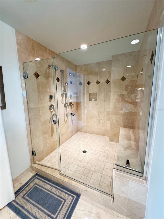 1111 Ritz Carlton Drive, Unit 1404 Sarasota, FL 34236 - Photo 35 of 69 a bathroom with a glass shower door