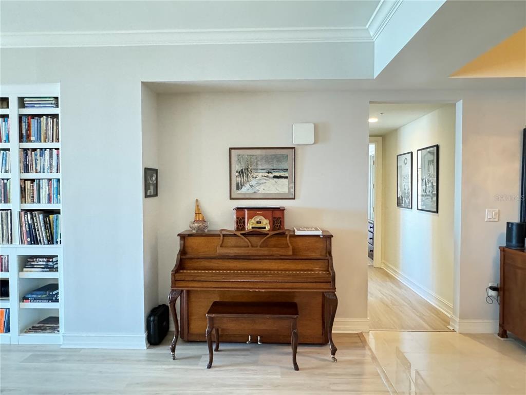 1111 Ritz Carlton Drive, Unit 1404 Sarasota, FL 34236 - Photo 4 of 69 a bedroom with a bed and a book shelf