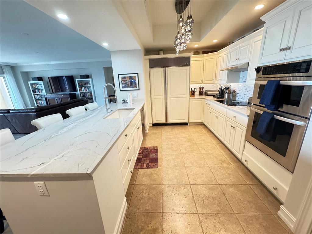 1111 Ritz Carlton Drive, Unit 1404 Sarasota, FL 34236 - Photo 5 of 69 a large kitchen with a large counter top appliances and cabinets