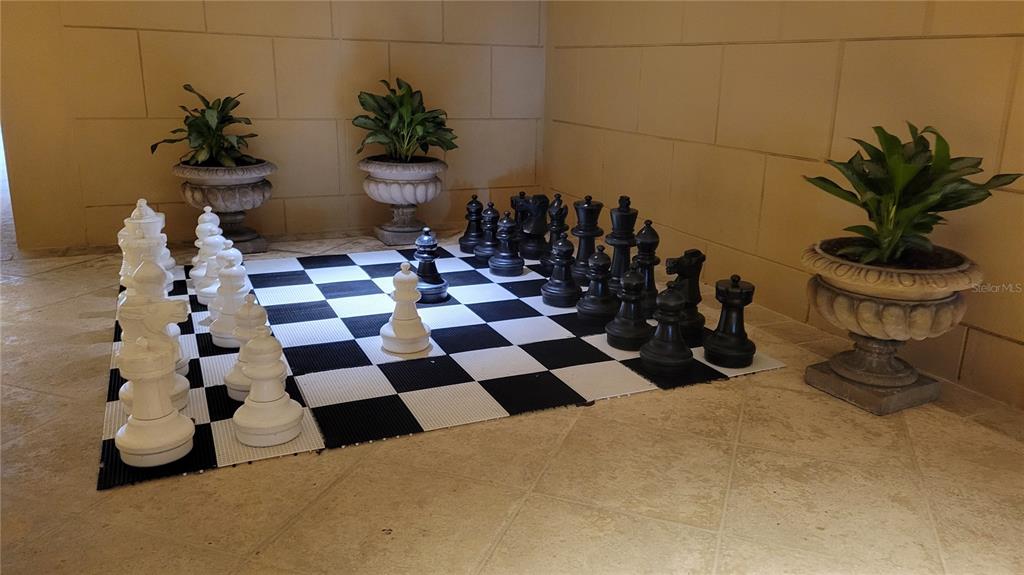 1111 Ritz Carlton Drive, Unit 1404 Sarasota, FL 34236 - Photo 58 of 69 a room with a black white checkered floor and a white door